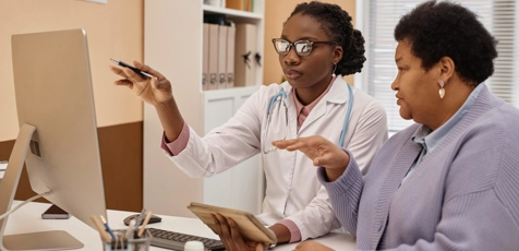 Female health practitioner explaining medical test on a computer